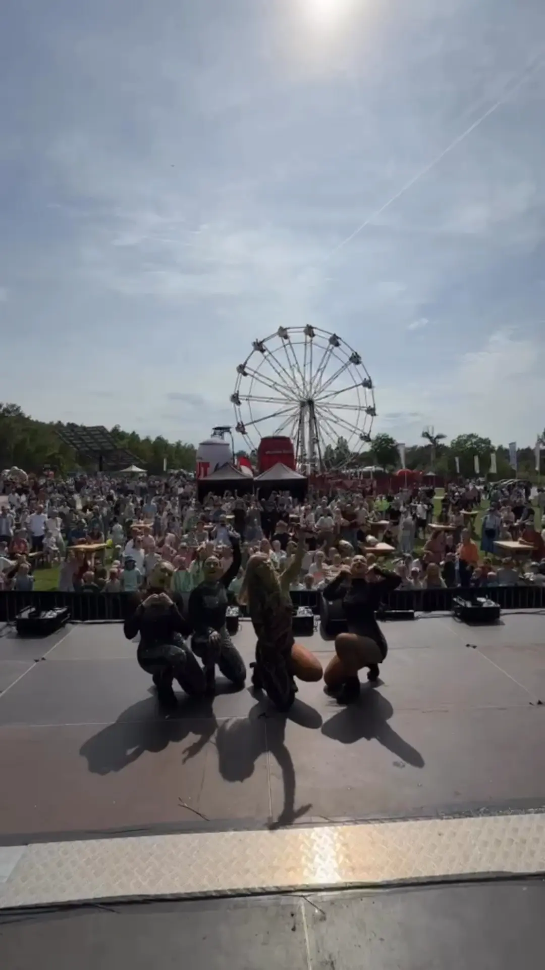 Performers on stage at a Taylor Swift tribute event, filmed vertically